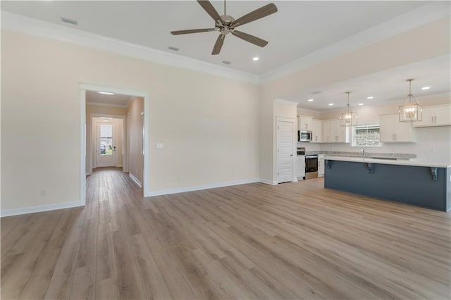 unfurnished living room with crown molding, visible vents, baseboards, light wood-type flooring, and ceiling fan with notable chandelier
