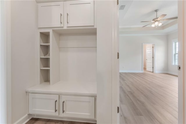mudroom featuring crown molding, a ceiling fan, baseboards, and light wood-style flooring