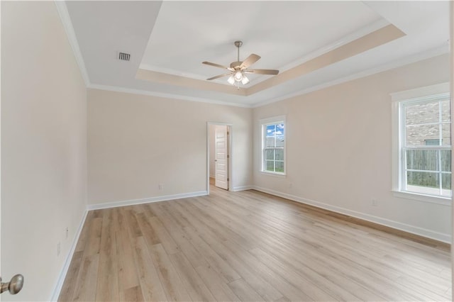 spare room with plenty of natural light, a raised ceiling, ceiling fan, and ornamental molding