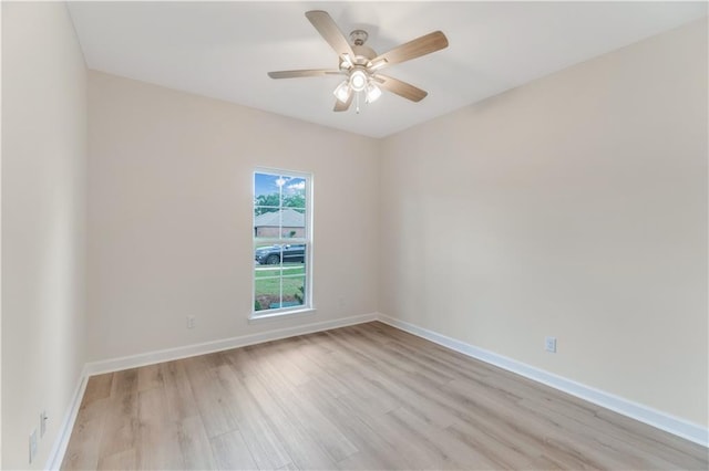unfurnished room featuring baseboards, a ceiling fan, and light wood finished floors