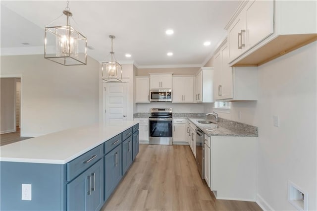 kitchen with crown molding, appliances with stainless steel finishes, blue cabinetry, and white cabinetry