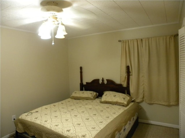 bedroom with ceiling fan and crown molding