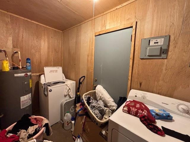 laundry area featuring electric water heater, washer and dryer, wood walls, and wooden ceiling