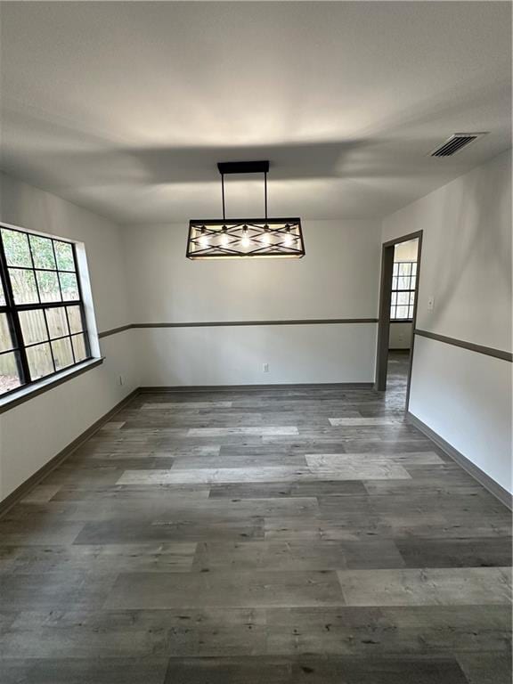 spare room featuring wood-type flooring