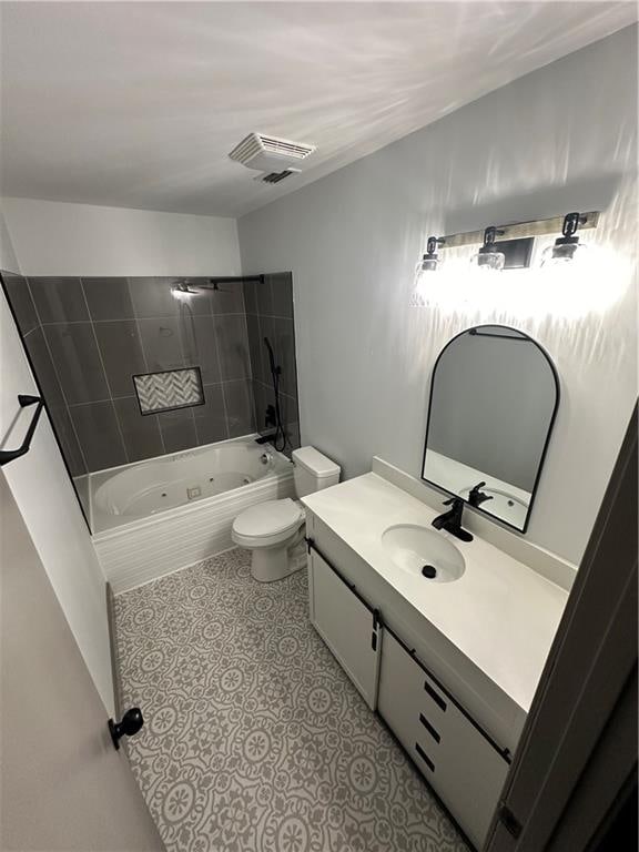 full bathroom with toilet, tiled shower / bath combo, and vanity