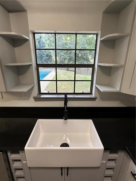 interior space with a wealth of natural light, sink, and white cabinetry