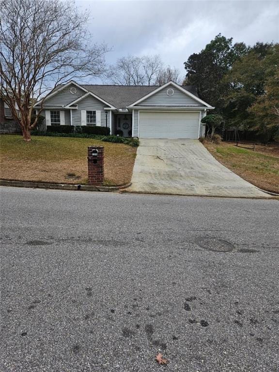 view of front of home featuring a garage and a front yard