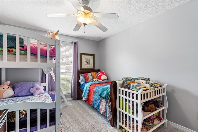 bedroom with ceiling fan, light colored carpet, and a textured ceiling