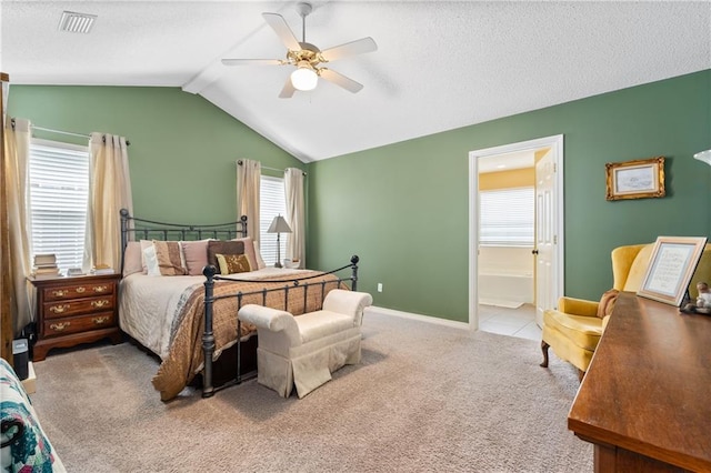 bedroom featuring ensuite bathroom, lofted ceiling with beams, ceiling fan, light carpet, and a textured ceiling