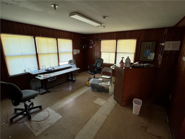 office space with wooden walls and tile patterned floors