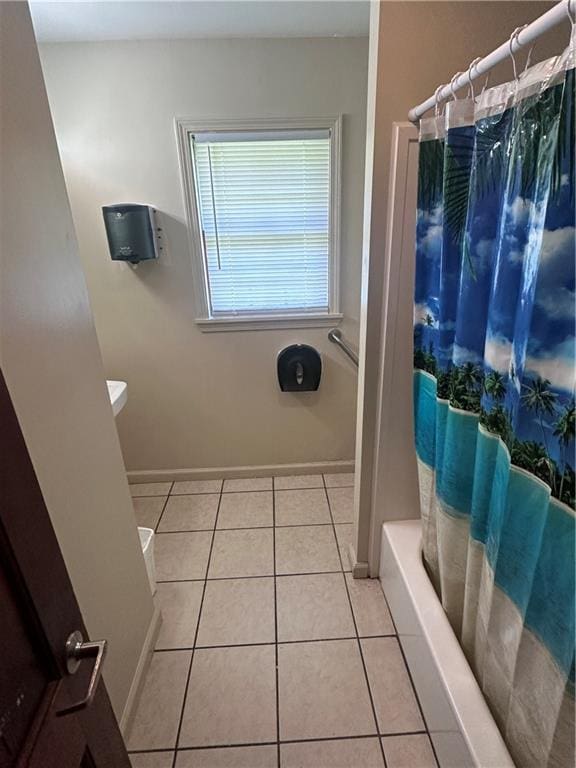 full bath with baseboards and tile patterned floors