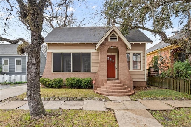 bungalow-style house with a front lawn