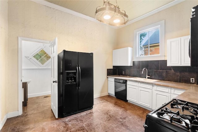 kitchen featuring white cabinets, ornamental molding, sink, and black appliances