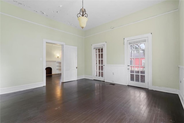 unfurnished room featuring a fireplace and dark wood-type flooring