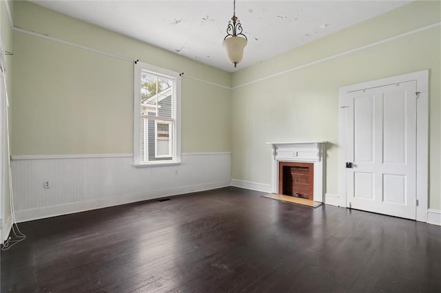 unfurnished living room featuring dark wood-type flooring
