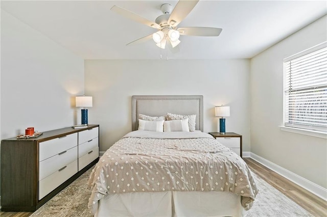 bedroom with light wood-type flooring and ceiling fan