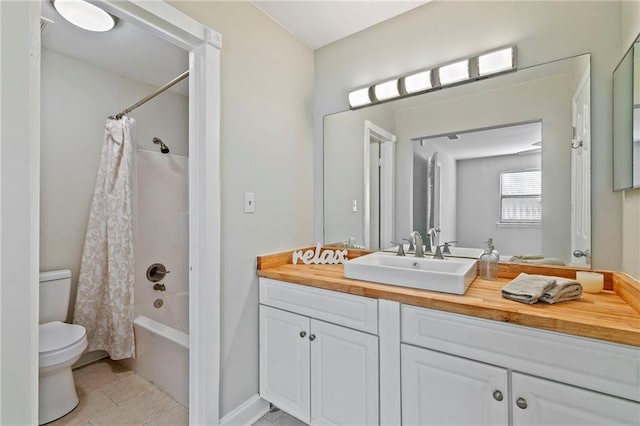 full bathroom featuring shower / tub combo with curtain, tile patterned floors, vanity, and toilet