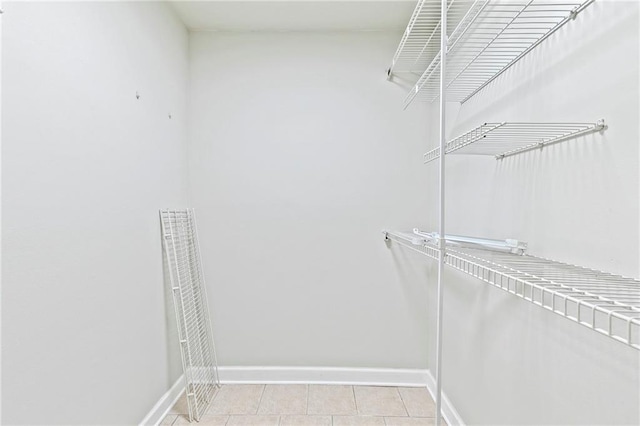 spacious closet featuring light tile patterned floors