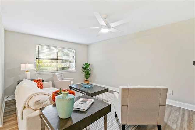 living room featuring light wood-type flooring and ceiling fan