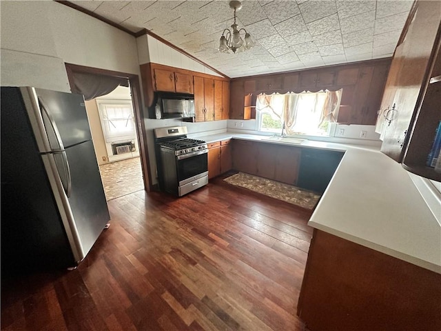 kitchen featuring a healthy amount of sunlight, dark hardwood / wood-style flooring, sink, and appliances with stainless steel finishes