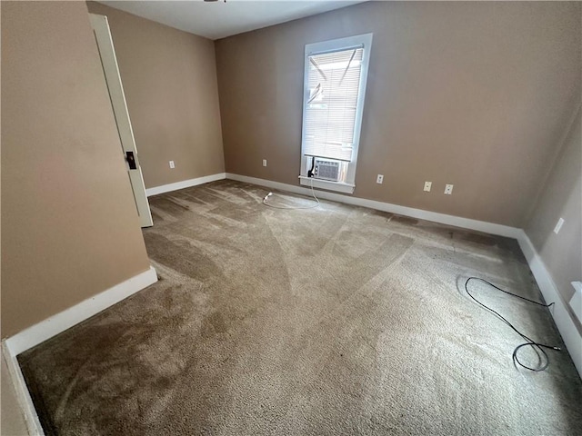 empty room featuring carpet floors, cooling unit, and ceiling fan