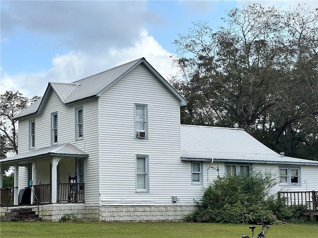 exterior space featuring covered porch and a front lawn