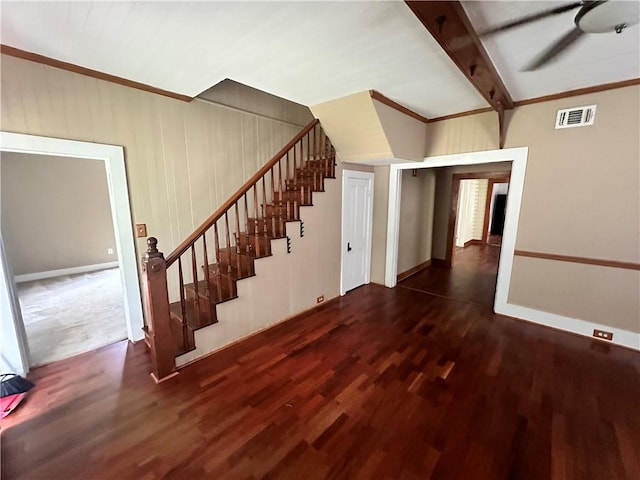 staircase featuring hardwood / wood-style floors, ceiling fan, crown molding, and beam ceiling