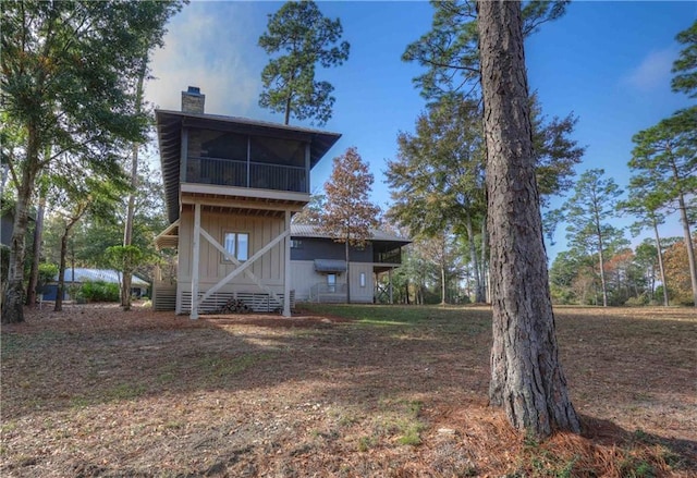 back of property with a sunroom