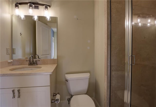 bathroom with vanity, an enclosed shower, and toilet