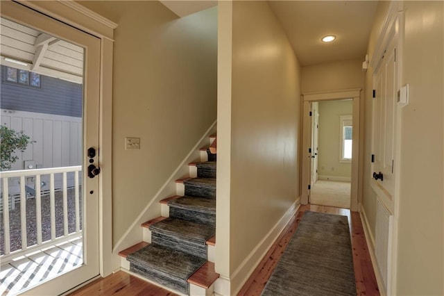 stairs with hardwood / wood-style floors