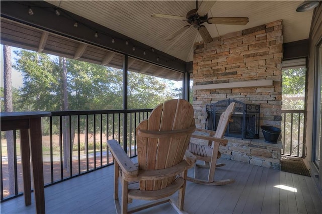 sunroom / solarium with plenty of natural light, wooden ceiling, and ceiling fan