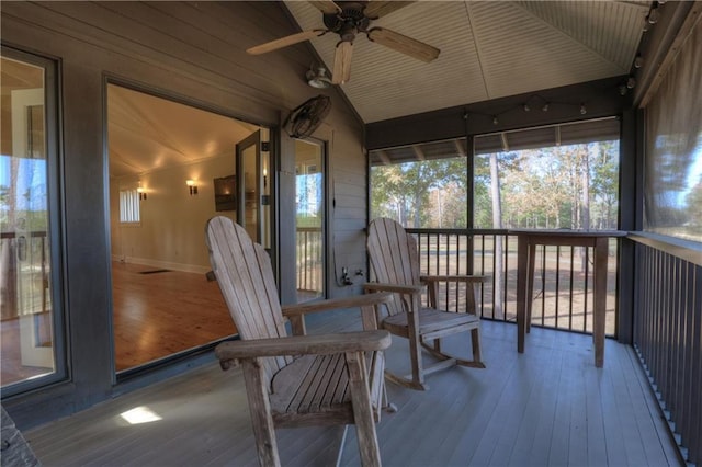 sunroom with ceiling fan, wood ceiling, and vaulted ceiling