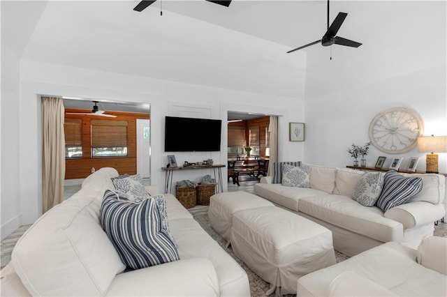 living area with ceiling fan and a high ceiling
