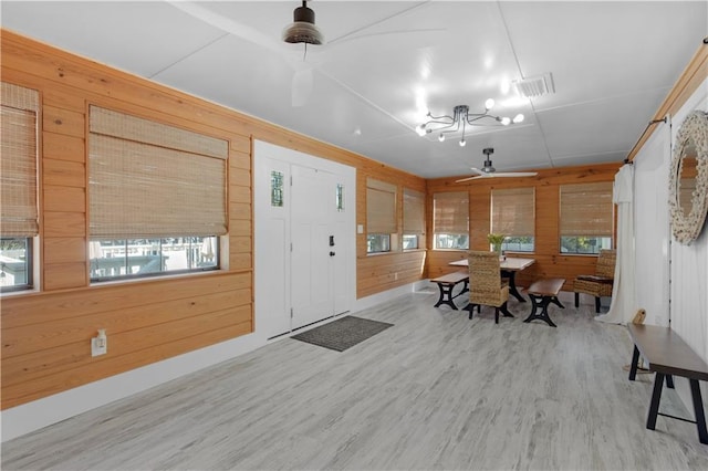 interior space featuring wood walls and a wealth of natural light