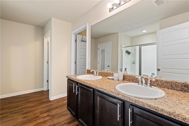 1951 Stonepine Dr, Semmes, AL 36575 - full bathroom with a stall shower, wood finished floors, and double vanity