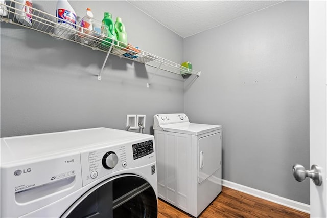 1951 Stonepine Dr, Semmes, AL 36575 - laundry room featuring washer and clothes dryer, wood finished floors, and a textured ceiling