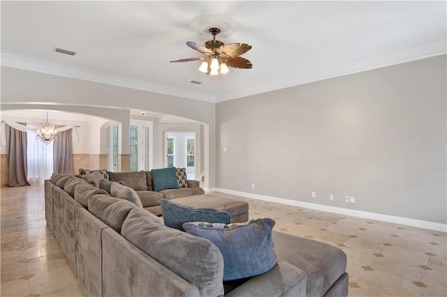 living room with ceiling fan with notable chandelier and crown molding