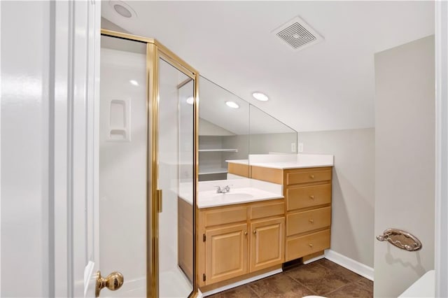 bathroom featuring tile patterned floors, vanity, and walk in shower