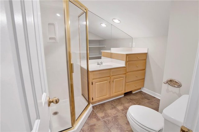 bathroom featuring vanity, toilet, and a shower with door