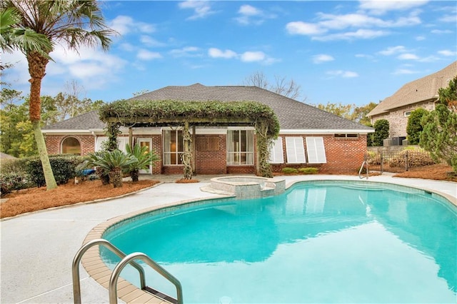 view of swimming pool featuring an in ground hot tub