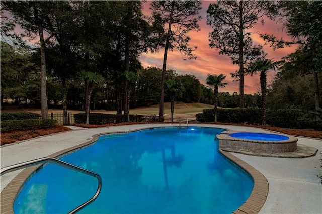 view of pool at dusk