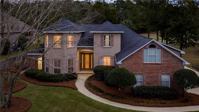 view of front facade featuring french doors and a front lawn