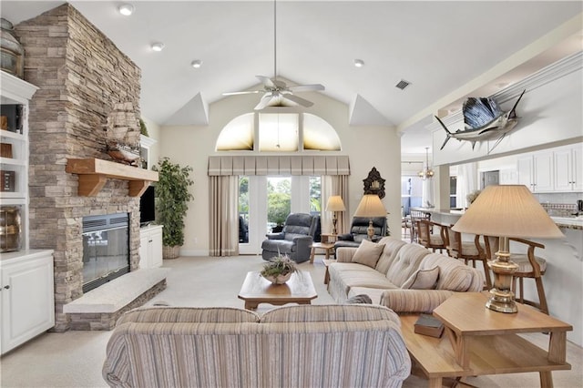 30077 River Rd, Orange Beach, AL 36561 - living area featuring light colored carpet, a stone fireplace, a ceiling fan, and high vaulted ceiling
