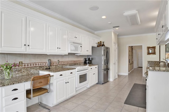 30077 River Rd, Orange Beach, AL 36561 - kitchen featuring white appliances, white cabinets, tasteful backsplash, light tile patterned floors, and crown molding