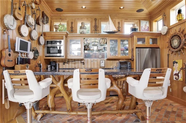 30077 River Rd, Orange Beach, AL 36561 - dining space featuring brick flooring, bar with sink, wooden walls, wooden ceiling, and recessed lighting