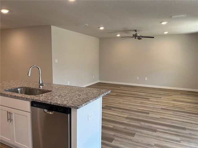 kitchen with ceiling fan, dishwasher, sink, white cabinets, and hardwood / wood-style flooring