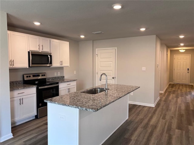 kitchen with white cabinets, dark wood-type flooring, and stainless steel appliances