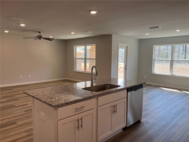 kitchen featuring a center island with sink, ceiling fan, a healthy amount of sunlight, sink, and dishwasher