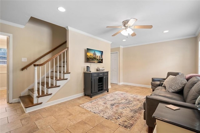 living room featuring a ceiling fan, crown molding, baseboards, and stairs