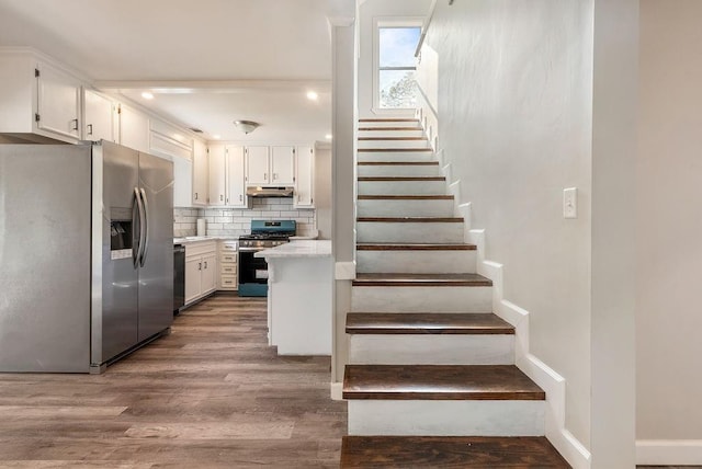 stairs with wood-type flooring